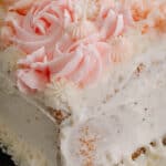 Close up view of the corner of the cake with buttercream icing.