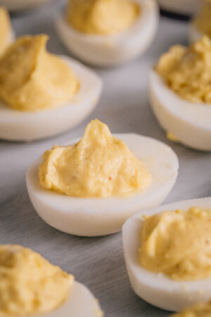 Creamy deviled eggs on a platter.