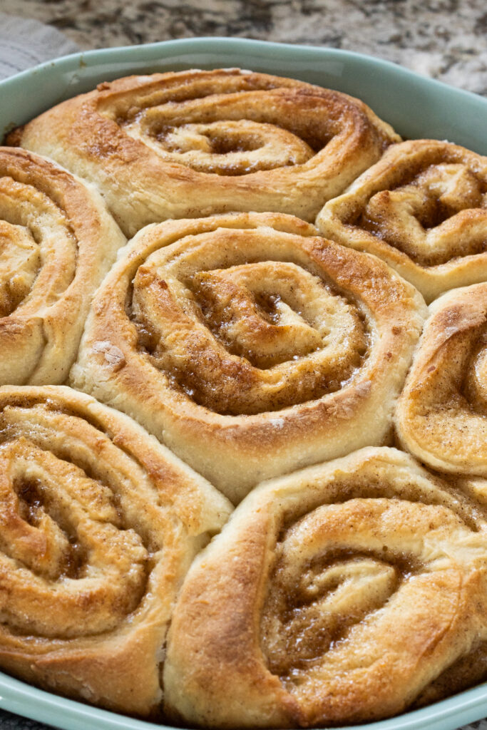 Close up of baked cinnamon rolls made with mash potatoes.
