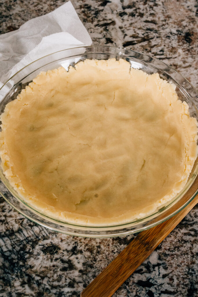 Unbaked pie crust that was molded by fingers.