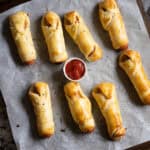 Eight mummies in a blanket or hot dogs baked in crescent rolls hot and ready to eat!