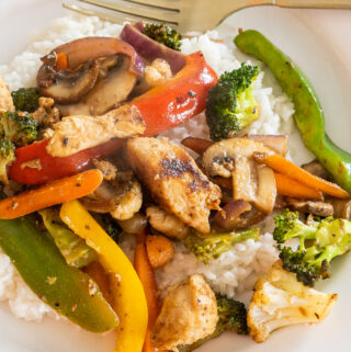 Chicken, peppers, onions, mushrooms, carrots, and broccoli all fried and served over a bed of rice make this Chicken Stir Fry so delicious!