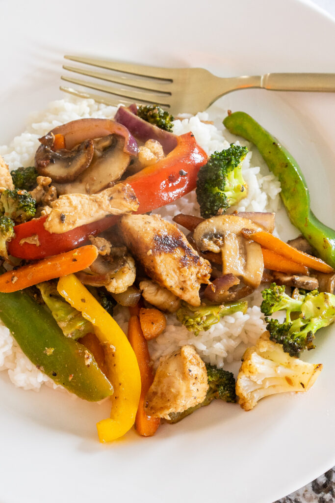 Chicken, peppers, onions, mushrooms, carrots, and broccoli all fried and served over a bed of rice make this Chicken Stir Fry so delicious!