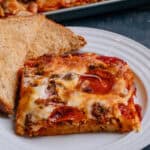 Plated pizza spaghetti with poor mans garlic bread.