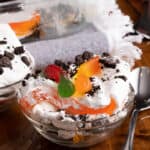 A small bowl of this Halloween dirt dessert garnished with gummy worms coming out of the top of Oreos. A great spooky dessert!