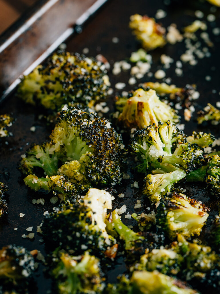 Straight from the oven; hot and yummy roasted broccoli on a baking sheet ready to be served.