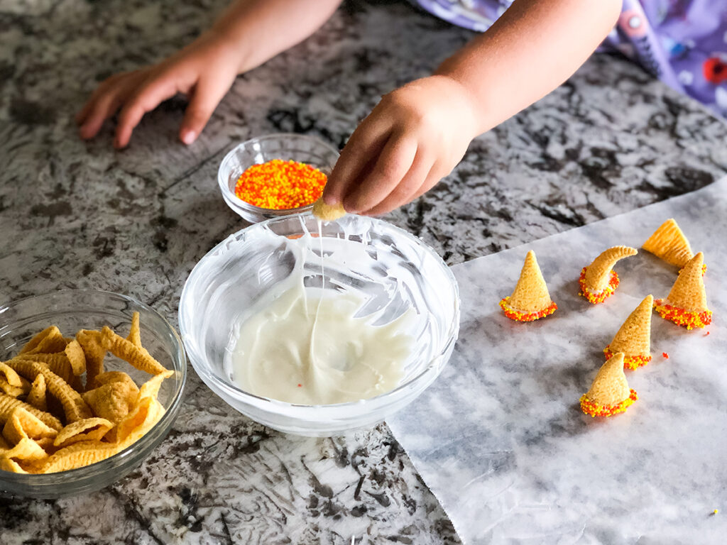 White chocolate, original Bugles and sprinkles to make witches' hats for the ultimate Halloween party mix.