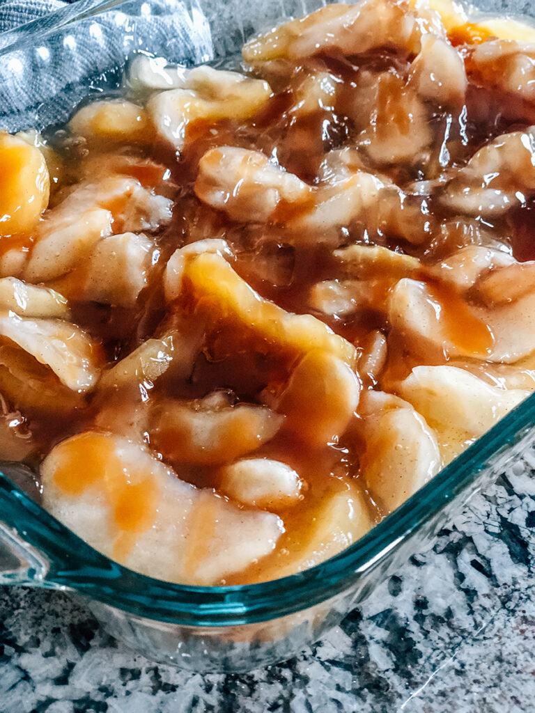 Close up of the apple pie filling drizzled in caramel syrup.