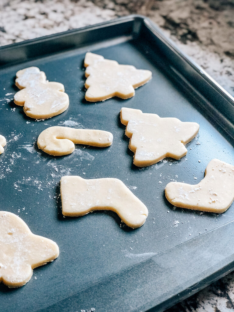 Cut out sugar cookies on a baking sheet ready for the oven.