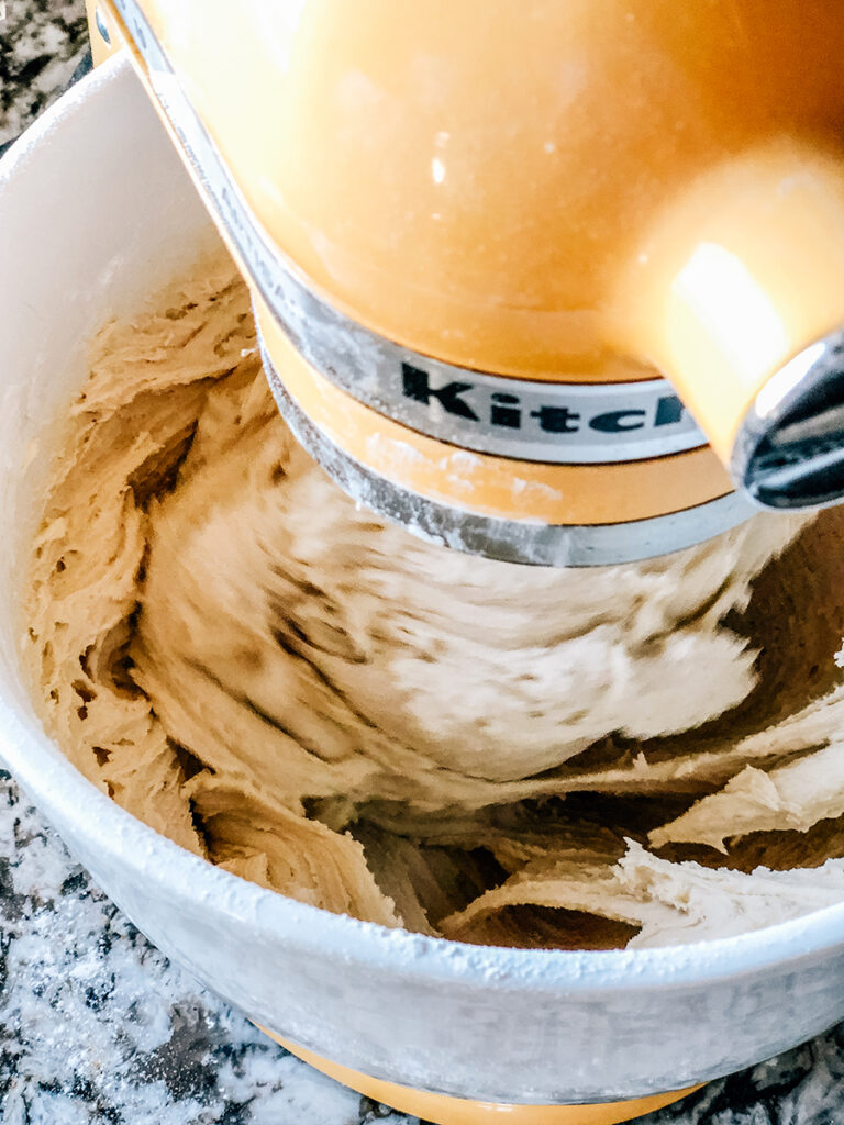 Sugar cookie dough mixing in a stand mixer.