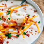 A bowl full of cream cheese potato soup ready to be eaten.