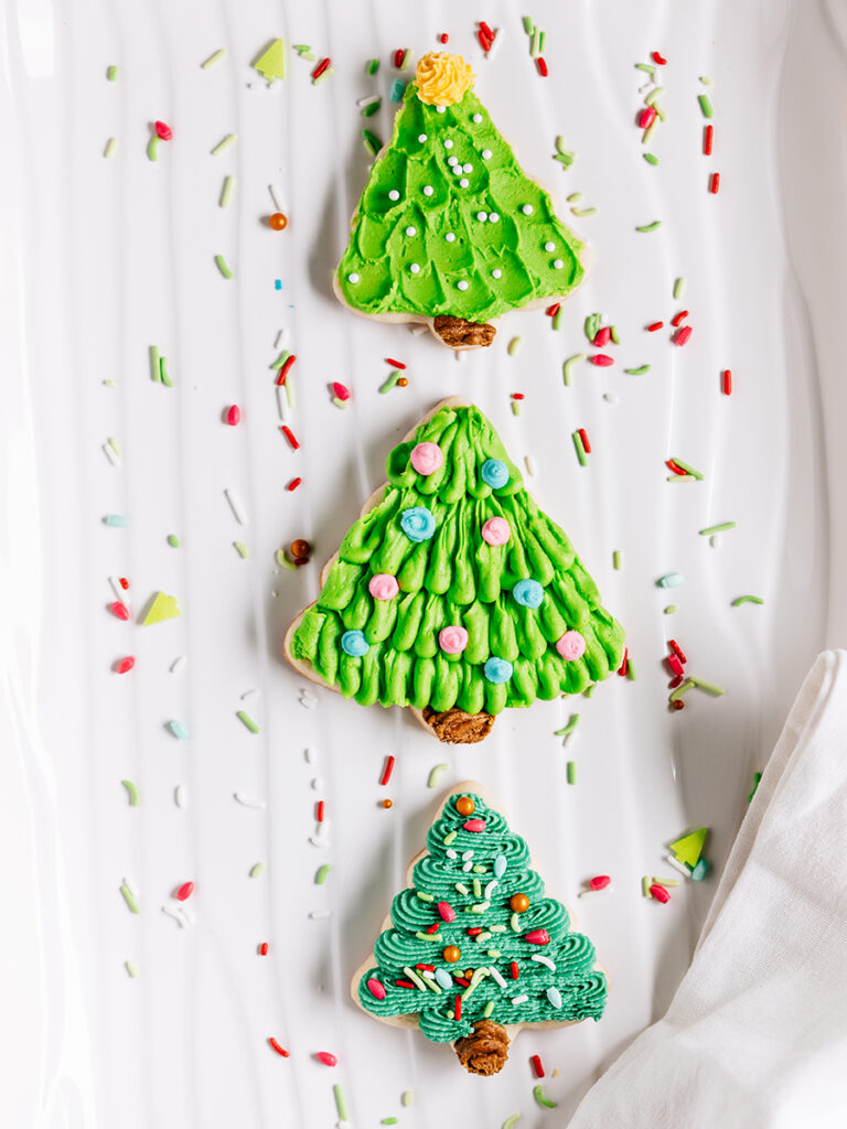 Christmas tree sugar cookies with a hint of lemon on a plate.