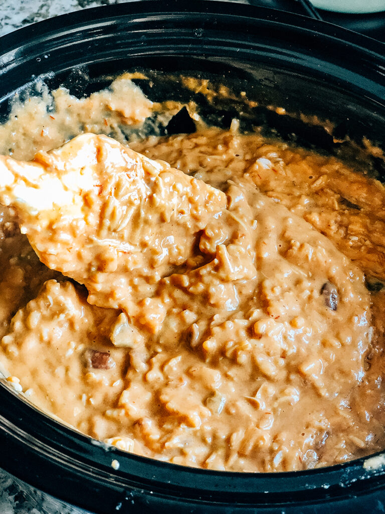 Melted and warm jambalaya chip dip in crockpot