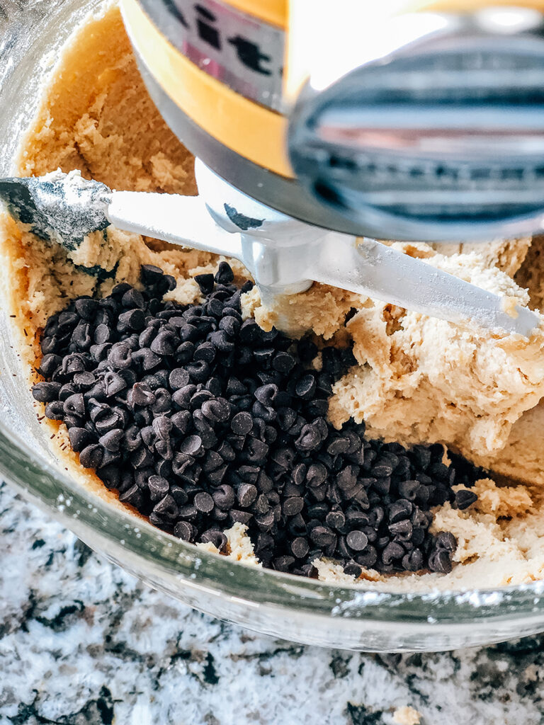 Adding semi-sweet mini chocolate chips to the edible cookie dough.