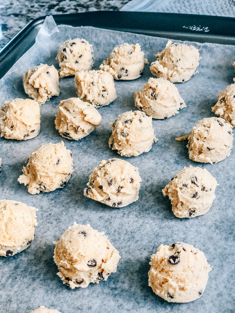 Edible cookie dough in 1" balls on wax paper.