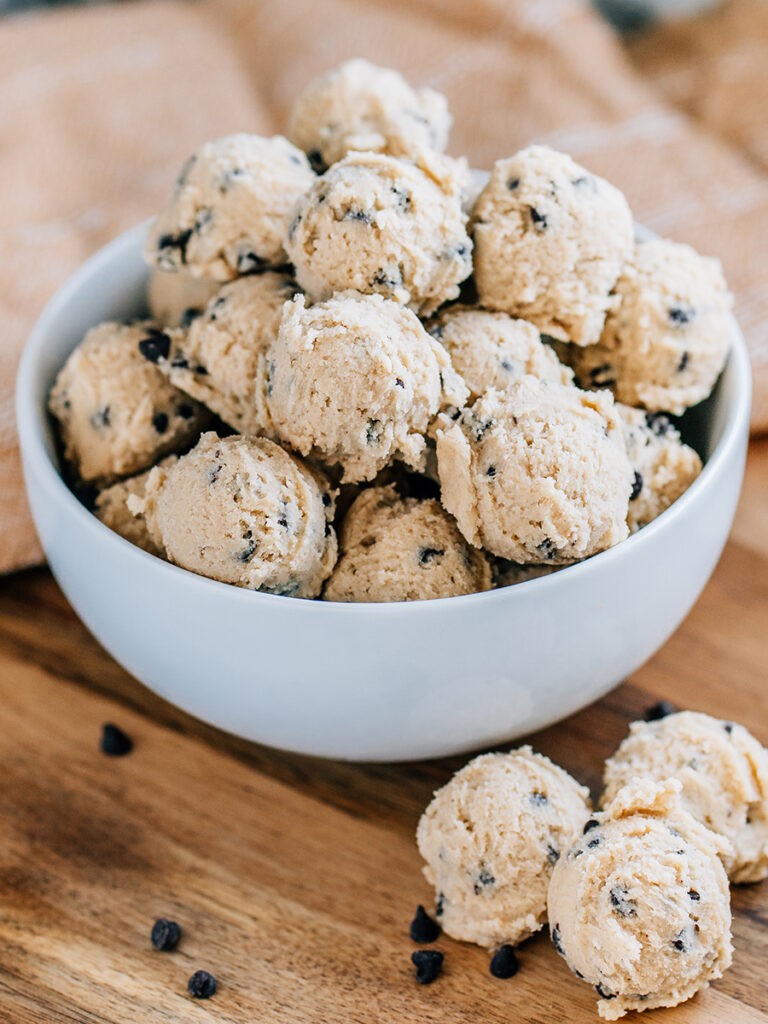 A bowl full of edible cookie dough balls ready to eat as snack or sweet reat.
