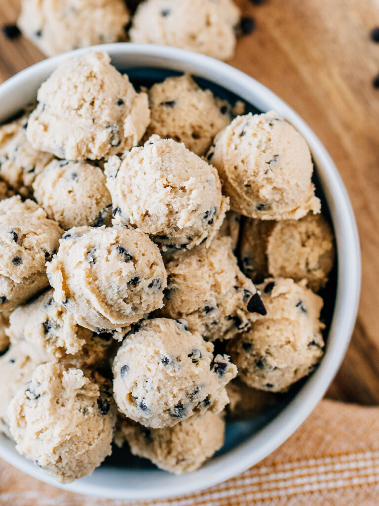 Overview shot of a bowl full of edible cookie dough balls ready to eaten as the perfect snack