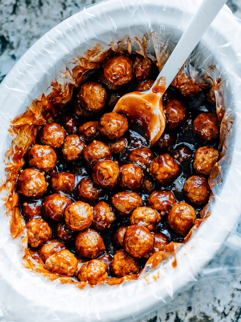 A crockpot of honey garlic bbq meatballs the best party dish for sweet with a heat bit of heat.