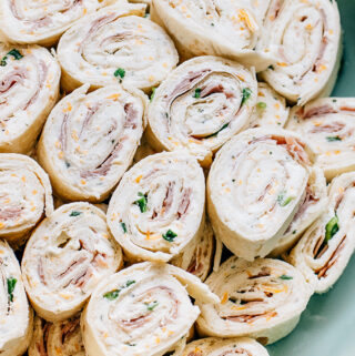A plate of delicious ham and cheese ranch roll ups. The best game day, dinner party or birthday appetizer!