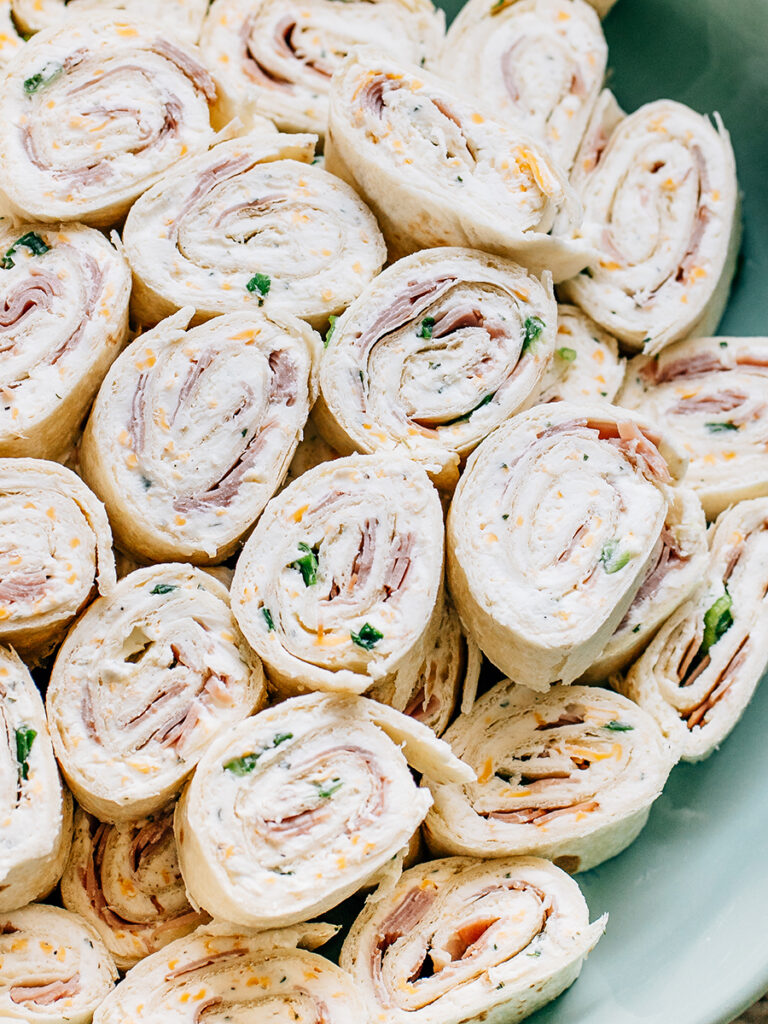 A plate of delicious ham and cheese ranch roll ups. The best game day, dinner party or birthday appetizer!