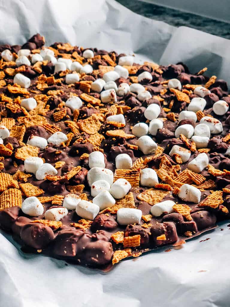 Side view of chocolate s'mores bark frozen in a single sheet before cut into squares.