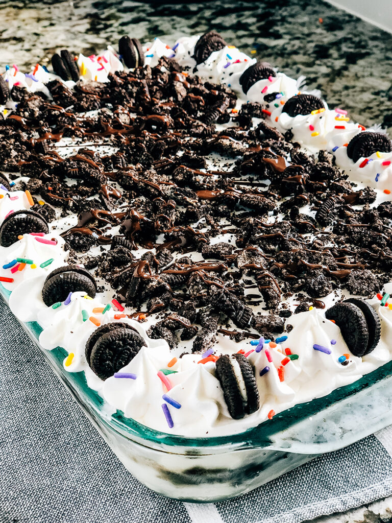 Add more roughly crushed oreos and other garnishes. We add cool whip dollops, mini oreos, and magic shell chocolate topping.