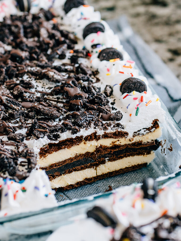 The inside view of the pan with missing cake pieces to show off the decadent layers of this easy ice cream cake.