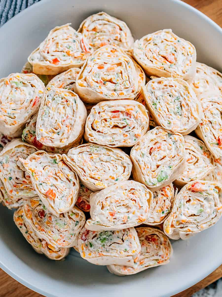 A photo of Veggie Roll Ups sliced and served on a white round platter - by The Recipe Life