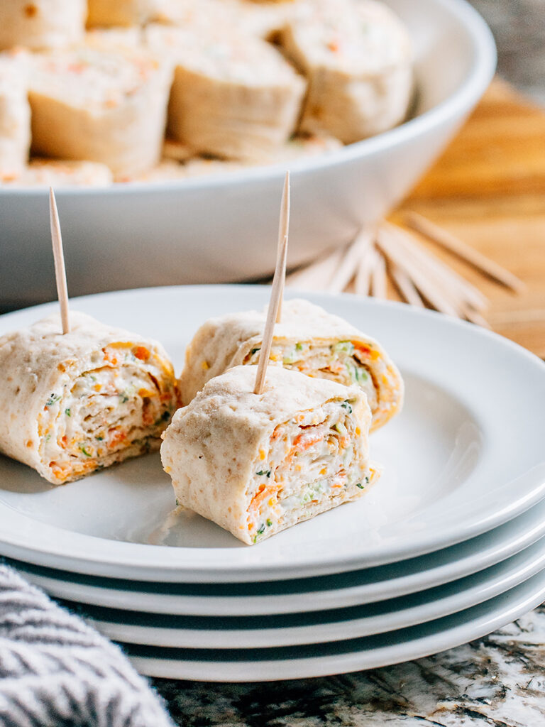 A single serving plate with three delicious and savory veggie roll ups.