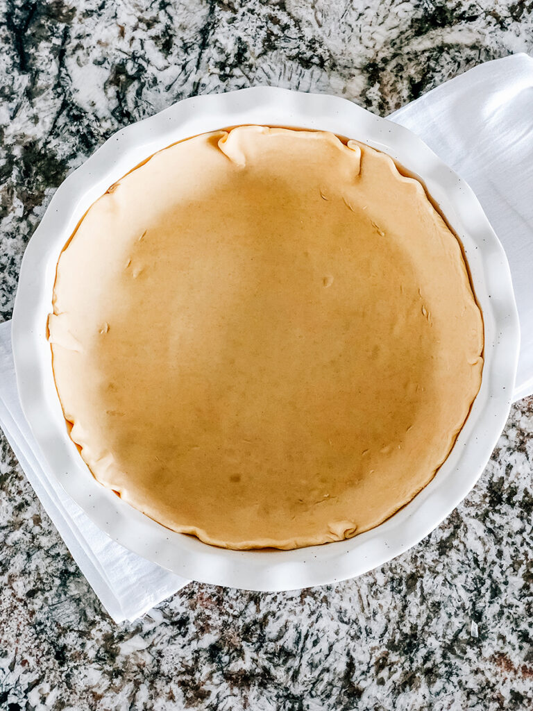 Pre-made pie crust fitted in the bottom of a 9 inch deep dish pie plate.