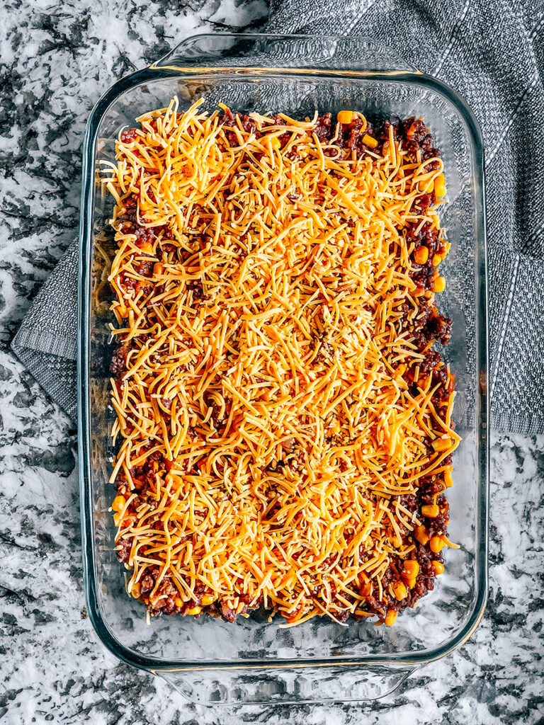 Layer the beef mixture on the bottom of a 9x13in baking dish and add the ther cup of shredded cheese on top of it.