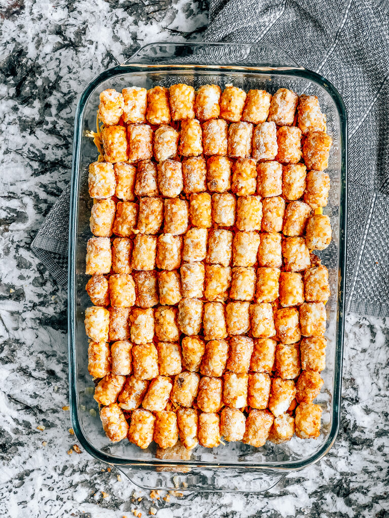 Top the casserole with a layer of frozen tater tots.