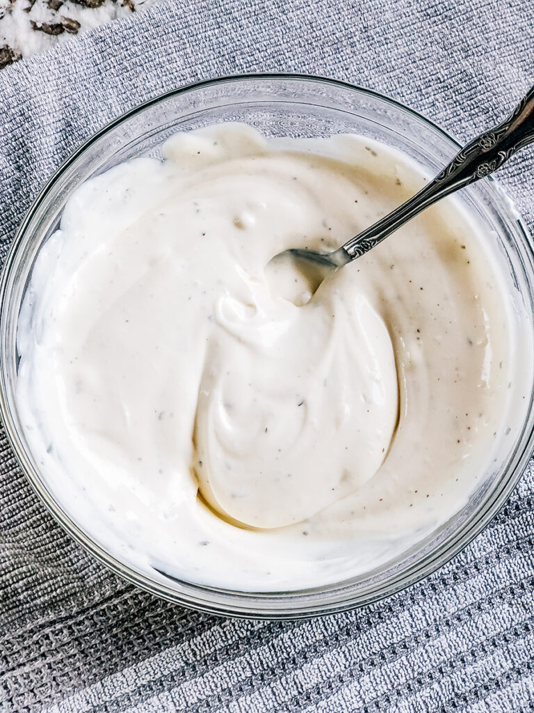 The homemade dressing of ranch and sour cream mixed together.