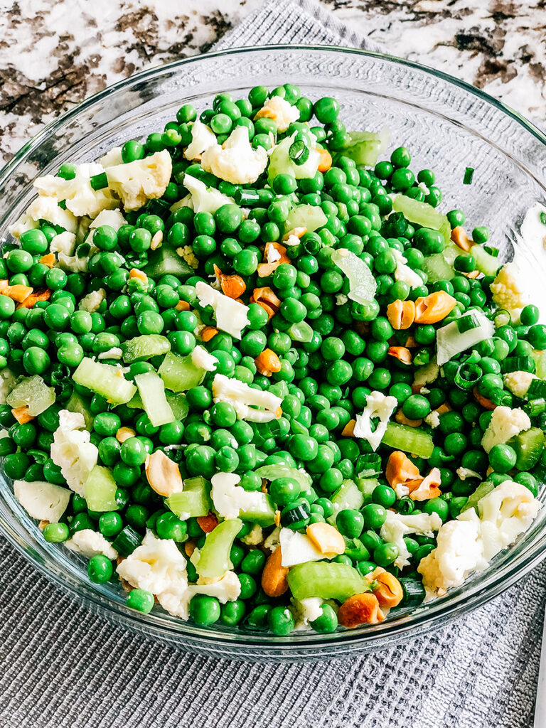 The diced and chopped ingredients gently mixed the peas.