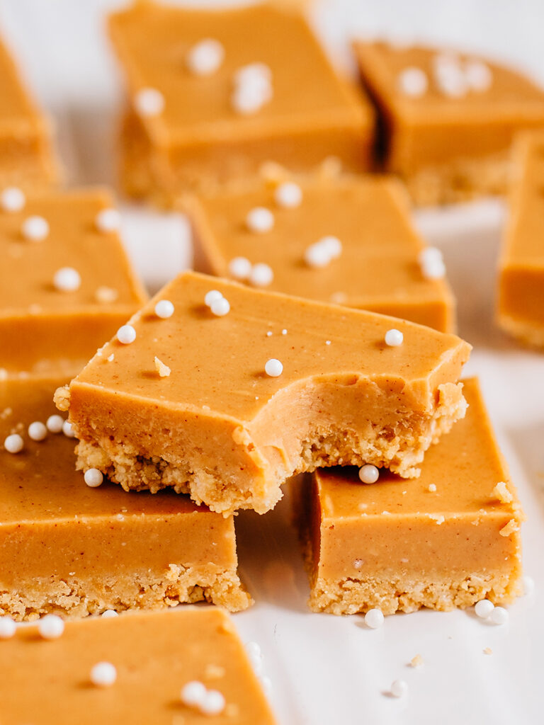 A no bake peanut butter bar with a bite taken out of it. SO yummy! Creamy and crunchy these bars are the best no bake dessert.