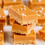 A stack of no bake peanut butter bars. They are the perfect blend of creamy and crunchy.
