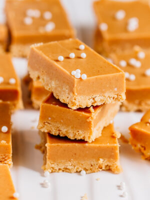 A stack of no bake peanut butter bars. They are the perfect blend of creamy and crunchy.