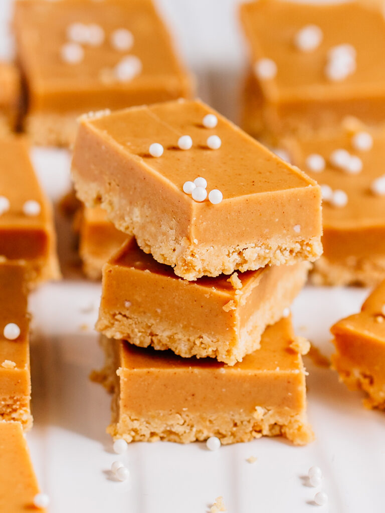 A stack of no bake peanut butter bars. They are the perfect blend of creamy and crunchy.