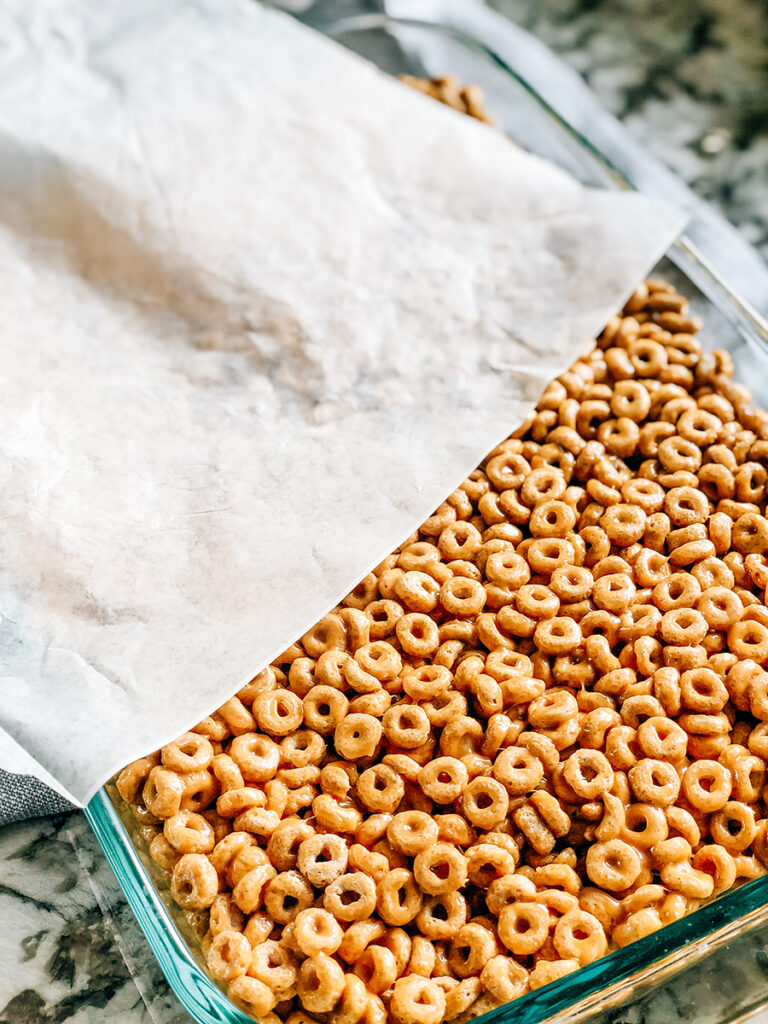 The coated Cheerios pressed into a 9x13 dish.