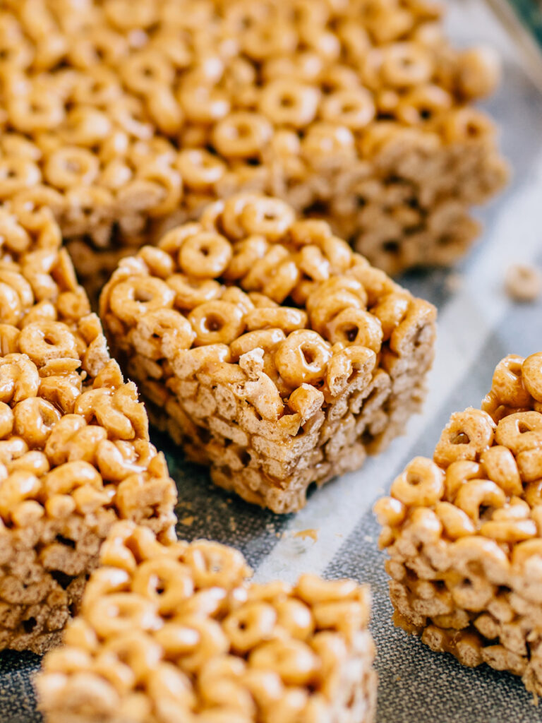 A close up of a Cheerio cereal bar covered in a sweet peanut butter sauce.