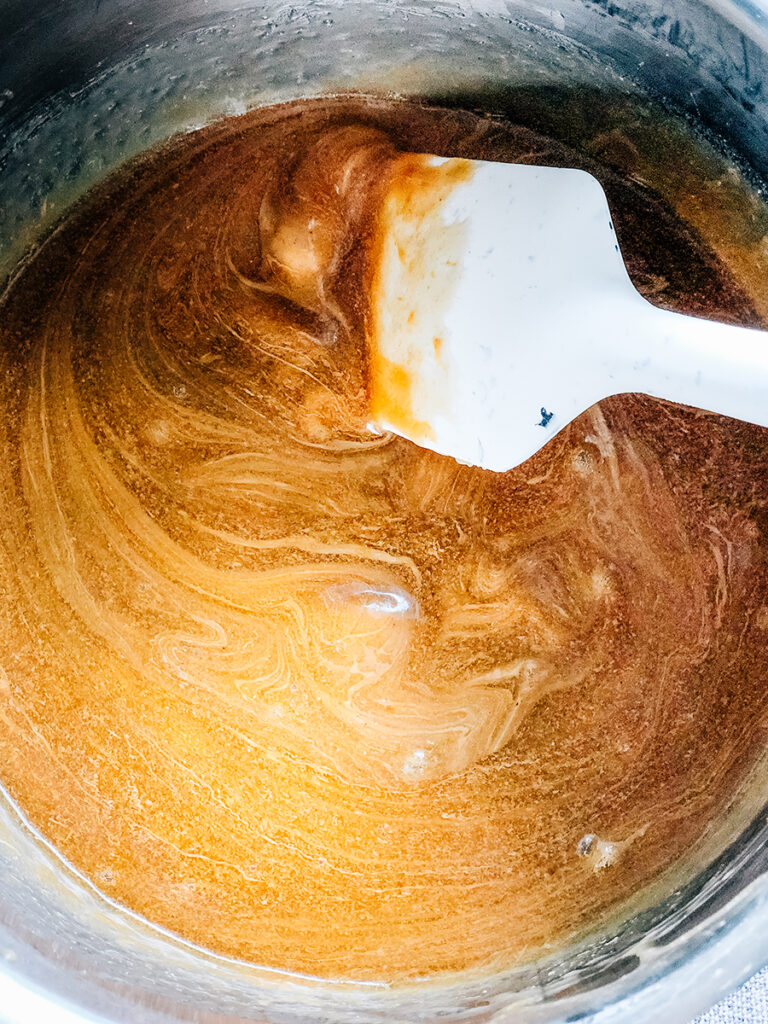 Peanut butter still being stirred into the sugar mixture.