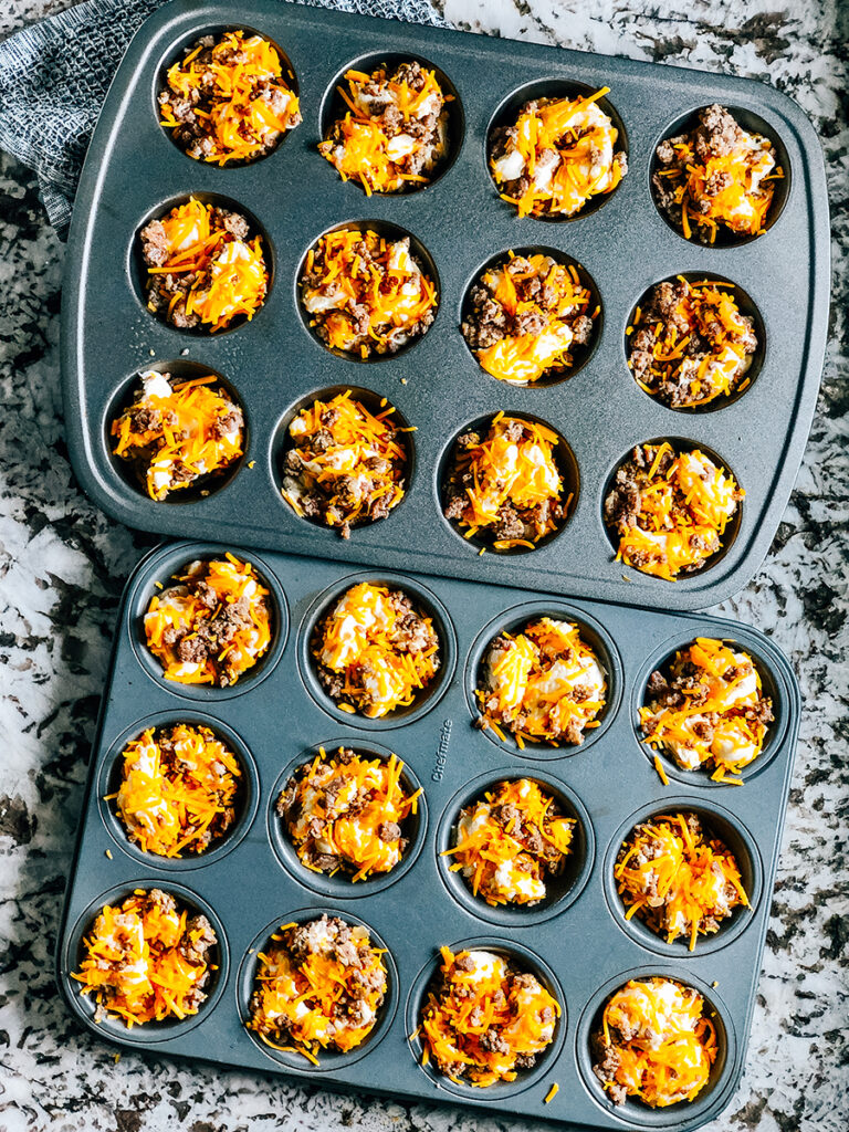 Pull apart sausage breakfast muffin mix separated into individual muffin tins and ready to be baked.