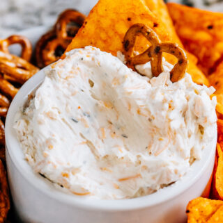 Creamy ranch beer cheese dip with a mini pretzel twist and dorito stuck in it make for the best game day munchie.
