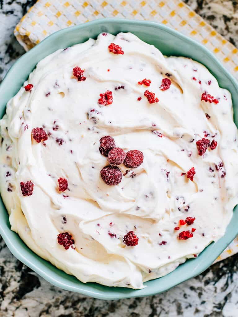 Top your raspberry fluff salad with a few frozen raspberries.