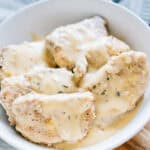Tender Ranch Pork Chops plated with a creamy gravy poured over them.