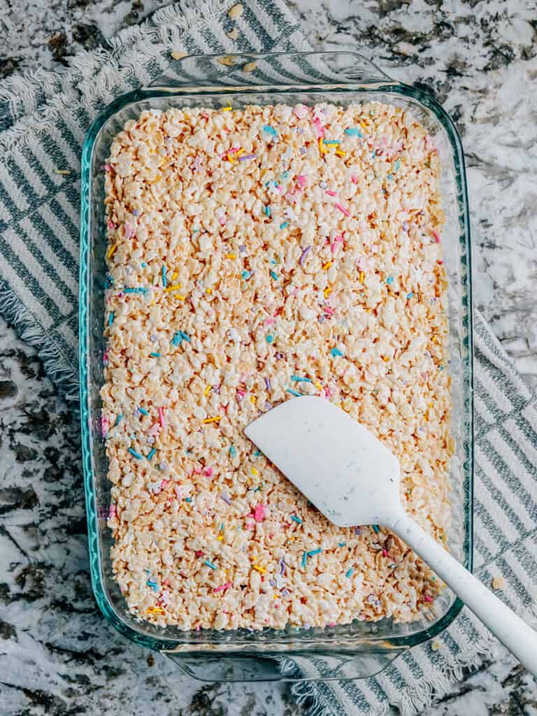 Overview photo of a 9x13 pan of rice krispies treats with sprinkles in them.
