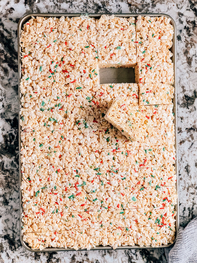 A 10x15 inch jelly roll pan filled with Christmas rice Krispies treats.