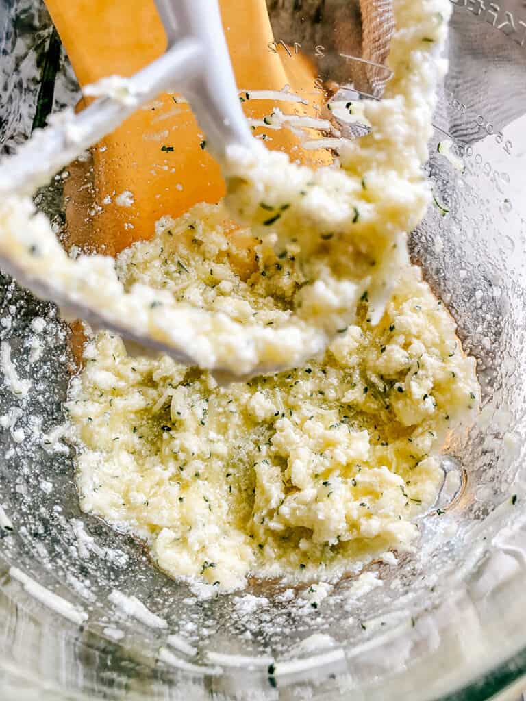 Shredded zucchini, egg, sugar and butter mixed together in a stand mixer.