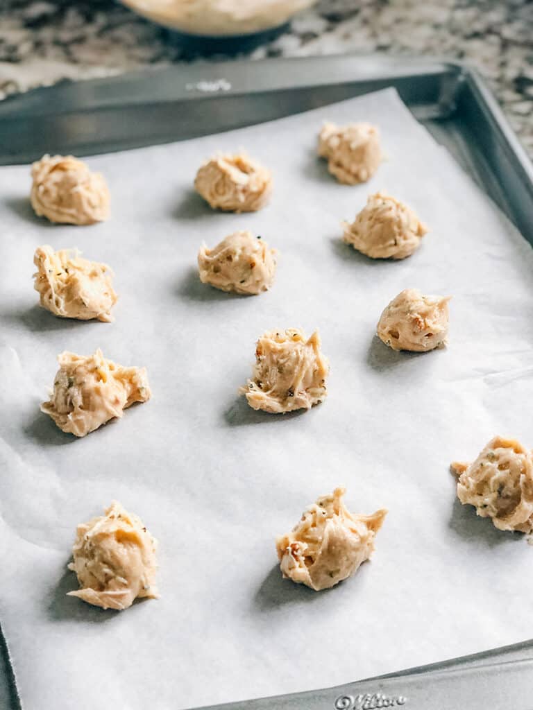Portioned cookie dough balls on a cookie sheet ready to be baked into delicious zucchini cookies.