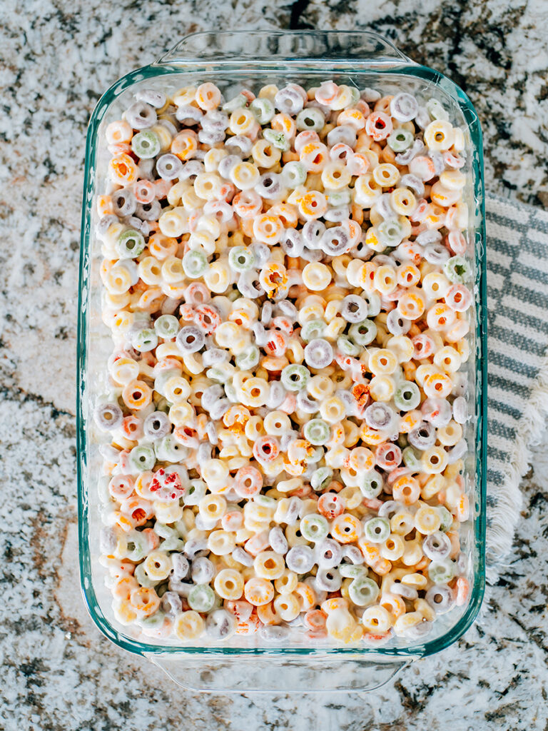 Overview of a pan of froot loops cereal treats on the counter cooling.